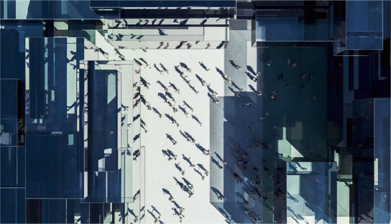 An aerial view of people walking through a business area